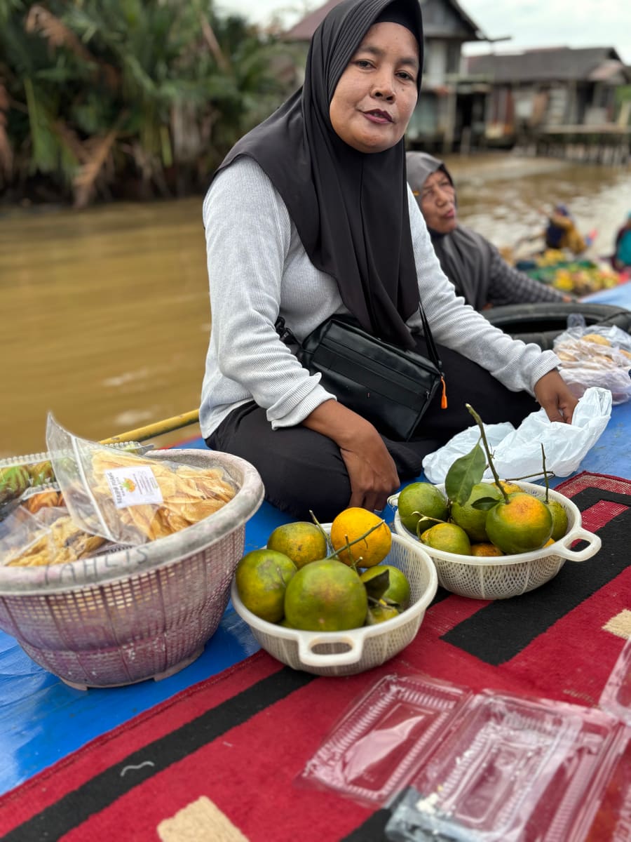 A vendor selling citrus at a floating market
